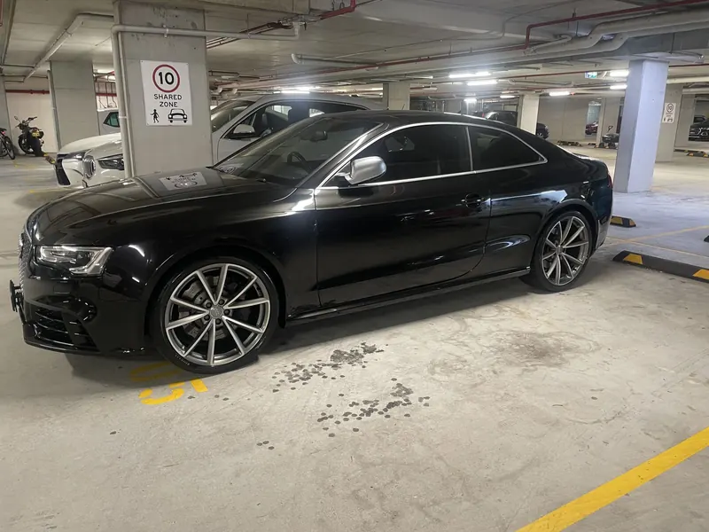 Black Audi sedan with a deep gloss after paint correction