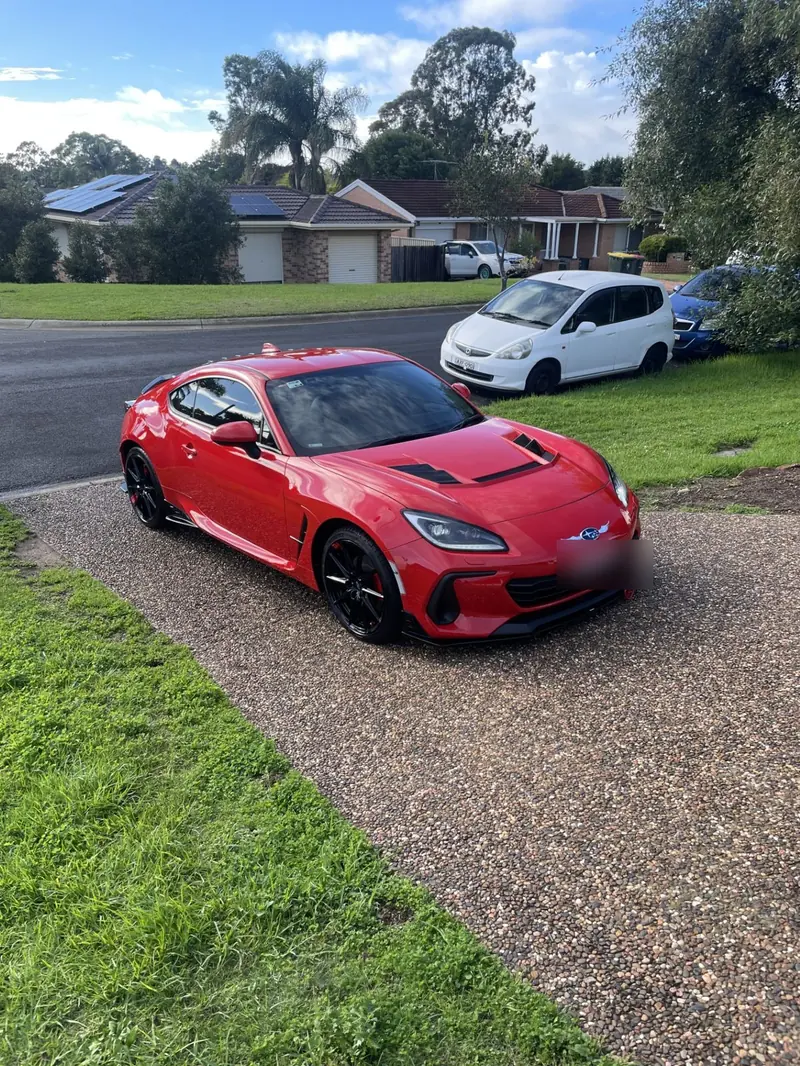 Presale car detailing: red sports coupe with a polished finish