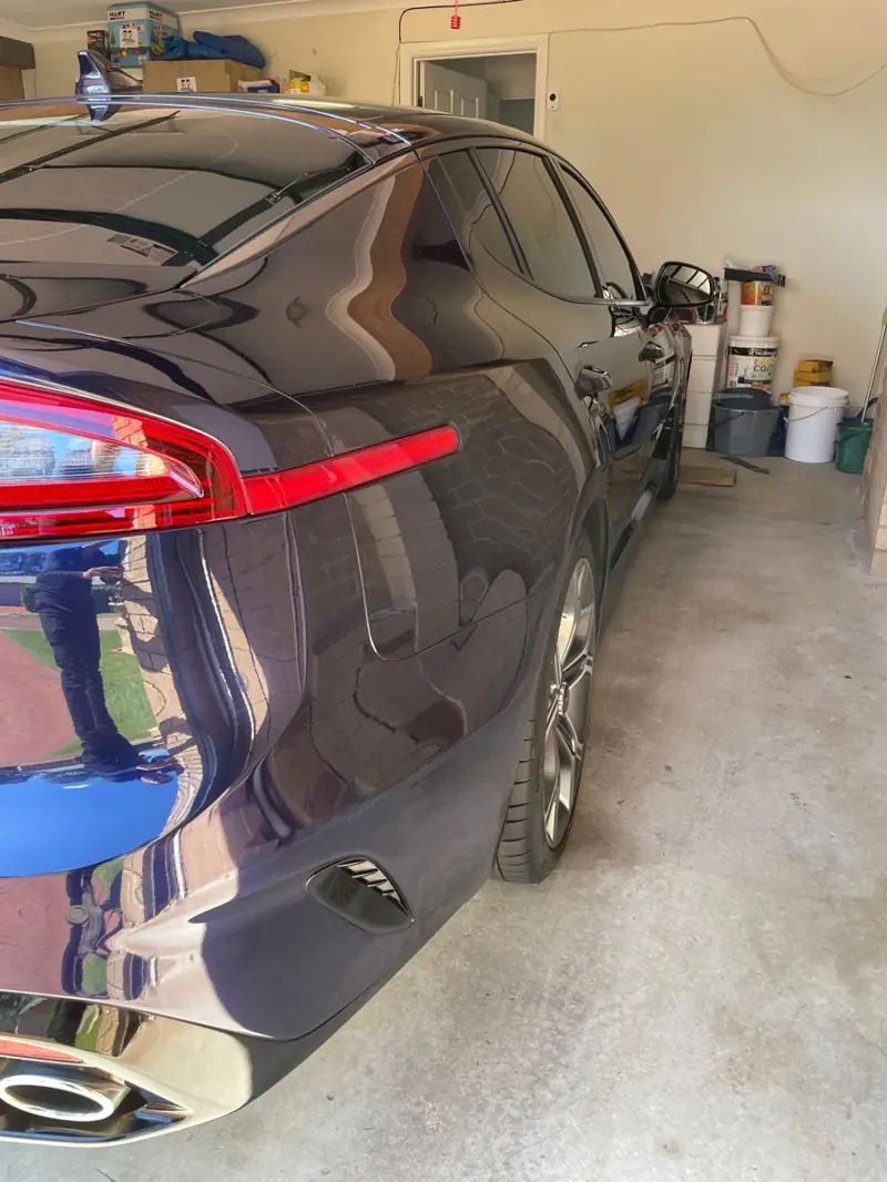 Clay bar treatment: smooth, glossy dark paint after decontamination