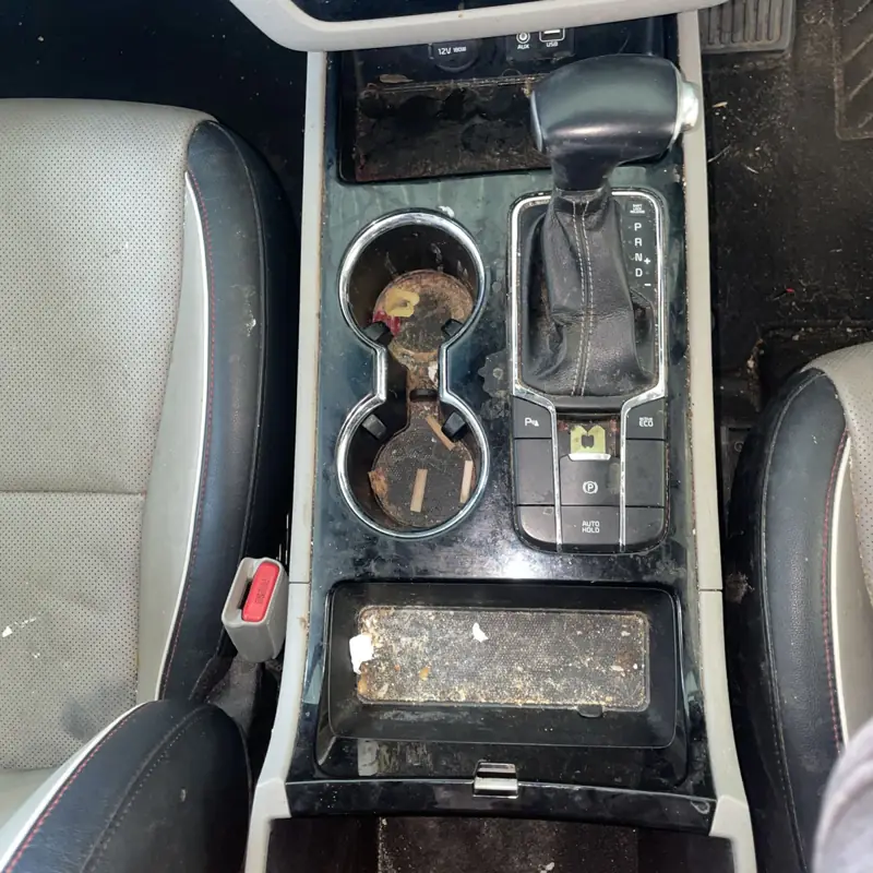 Car detailing in Thirlmere: dirty centre console before cleaning