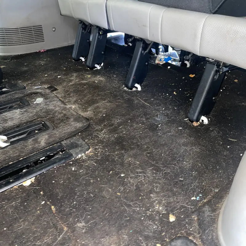 Car detailing in Macarthur: rear floor with crumbs and dirt before a detail